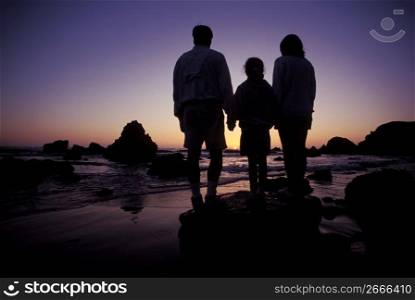 Family enjoying ocean view at sunset