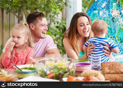 Family Enjoying Outdoor Meal At Home
