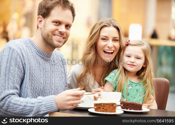 Family Enjoying Snack In Cafe Together