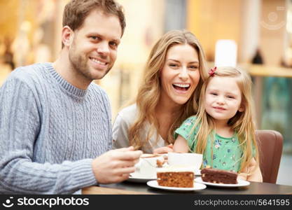 Family Enjoying Snack In Cafe Together