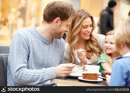 Family Enjoying Snack In Cafe Together