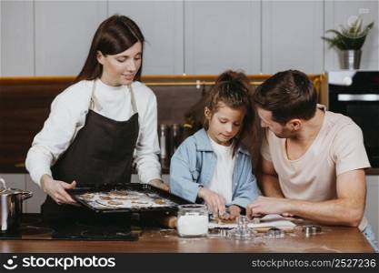 family father mother with daughter cooking together home