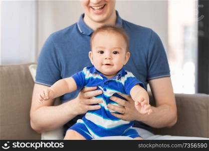 family, fatherhood and childhood concept - happy baby son with father at home. happy baby son with father at home