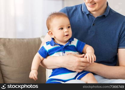 family, fatherhood and childhood concept - happy baby son with father at home. happy baby son with father at home