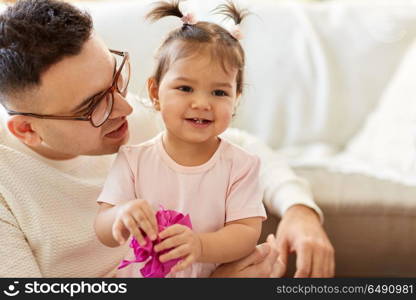family, fatherhood and people concept - close up of happy father and little daughter at home. close up of father and little daughter at home. close up of father and little daughter at home