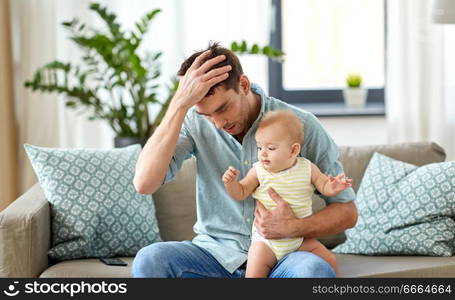 family, fatherhood and people concept - despaired father with little baby daughter at home. despaired father with little baby daughter at home