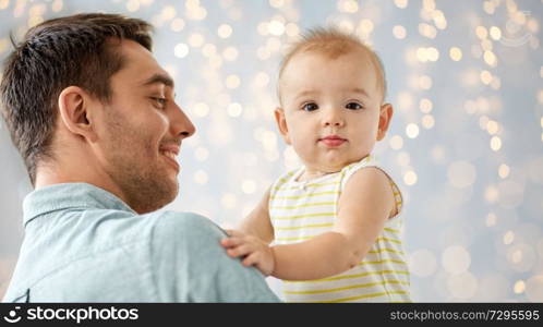 family, fatherhood and people concept - father with little baby daughter at home. father with little baby daughter at home