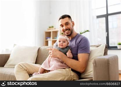 family, fatherhood and people concept - father with little baby girl at home. father with little baby girl at home