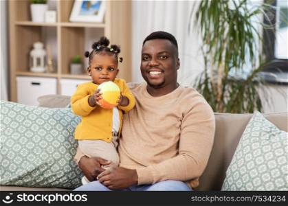 family, fatherhood and people concept - happy african american father with baby daughter at home. happy african american father with baby at home
