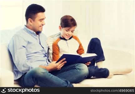 family, fatherhood, generation, literature and people concept - happy father and son reading book at home. happy father and son reading book at home