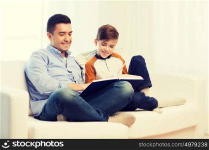 family, fatherhood, generation, literature and people concept - happy father and son reading book at home. happy father and son reading book at home