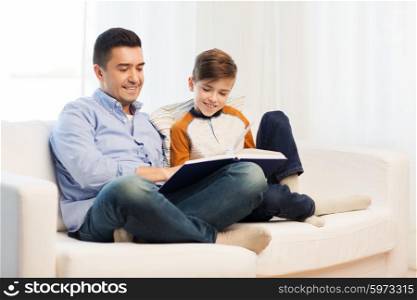 family, fatherhood, generation, literature and people concept - happy father and son reading book at home