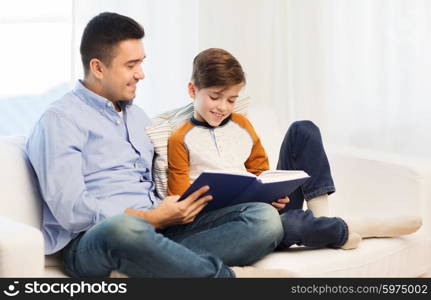 family, fatherhood, generation, literature and people concept - happy father and son reading book at home