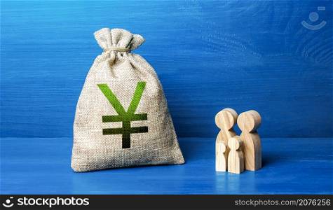 Family figurines and chinese yuan or japanese yen money bag. Family budget. Investment in human capital. Income, expenses. Refugees crisis. Favorable conditions for population growth. Demography.