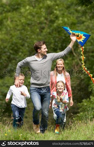 Family Flying Kite In Countryside