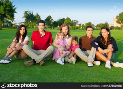 family friends group people sitting green grass outdoor with children