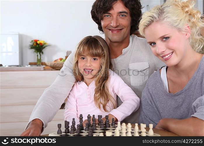 Family gathered by chess board