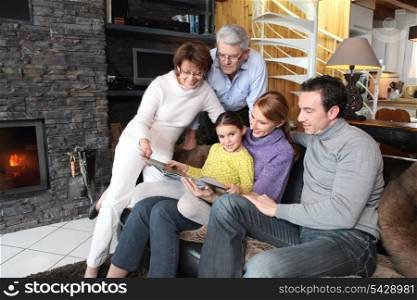 Family gathered together looking at photographs