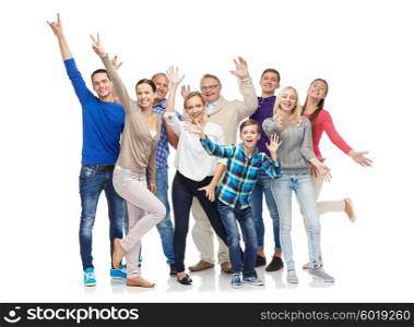 family, gender, generation and people concept - group of smiling men, women and boy having fun and waving hands