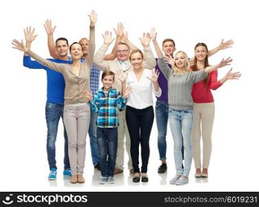 family, gender, generation and people concept - group of smiling men, women and boy waving hands