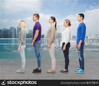 family, gender, high and people concept - group of men and women from side over singapore city waterside background