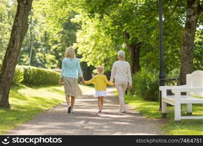 family, generation and people concept - happy mother, daughter and grandmother walking at park. mother, daughter and grandmother walking at park