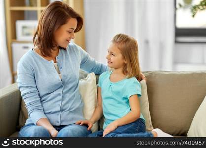 family, generation and people concept - happy smiling mother and daughter looking at each other at home. mother and daughter looking at each other at home