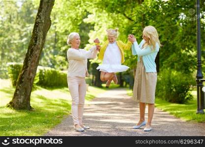 family, generation and people concept - happy smiling mother, daughter and grandmother having fun at park. happy mother, daughter and grandmother at park