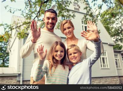 family, generation, home, gesture and people concept - happy family standing in front of house waving hands outdoors