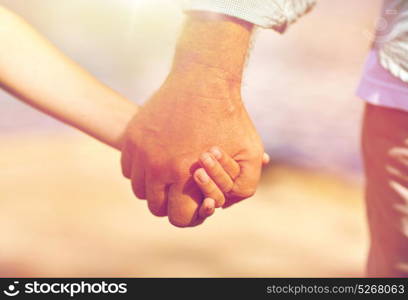 family, generation, support and people concept - senior man and child holding hands. senior man and child holding hands