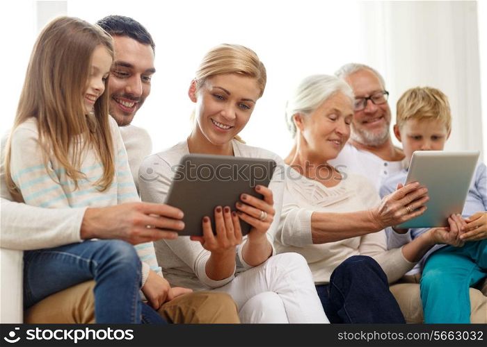 family, generation, technology and people concept - smiling family with tablet pc computers at home