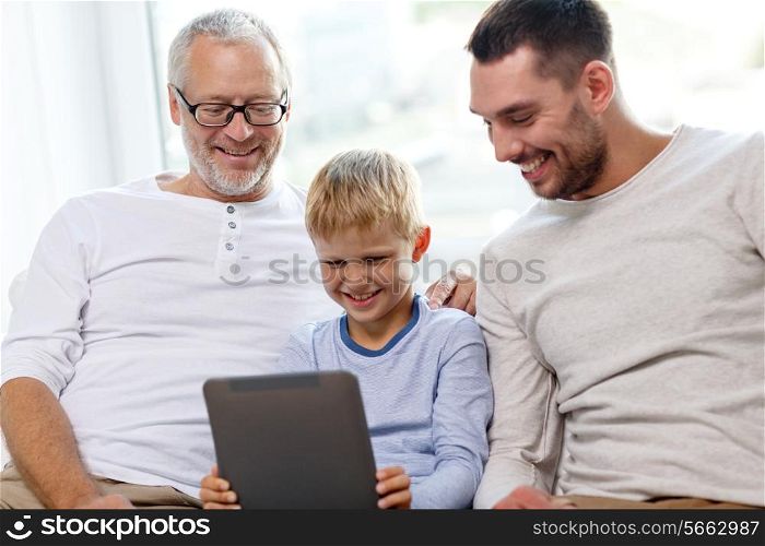 family, generation, technology and people concept - smiling father, son and grandfather sitting on couch with tablet pc computer at home