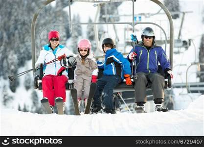Family Getting Off chair Lift On Ski Holiday In Mountains
