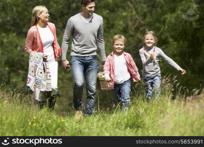 Family Going On Picnic In Countryside