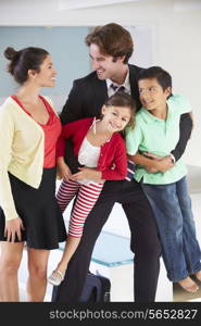 Family Greeting Father On Return From Work