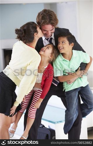 Family Greeting Father On Return From Work