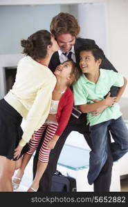 Family Greeting Father On Return From Work