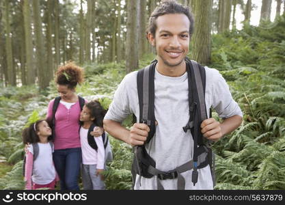 Family Group Hiking In Woods Together