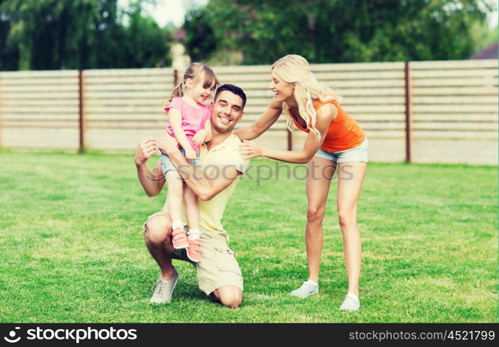 family, happiness, adoption and people concept - happy family hugging outdoors