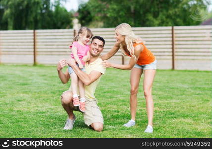 family, happiness, adoption and people concept - happy family hugging outdoors