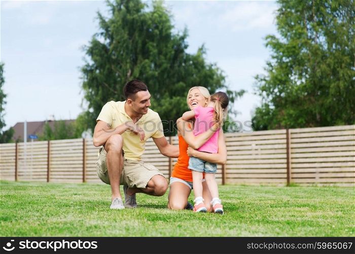 family, happiness, adoption and people concept - happy family hugging outdoors