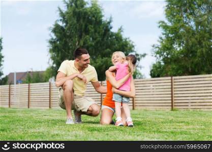 family, happiness, adoption and people concept - happy family hugging outdoors