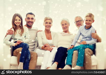 family, happiness, generation and people concept - happy family sitting on couch at home