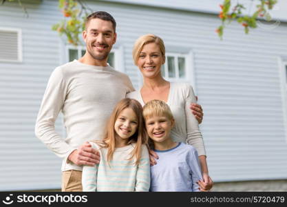 family, happiness, generation, home and people concept - happy family standing in front of house outdoors