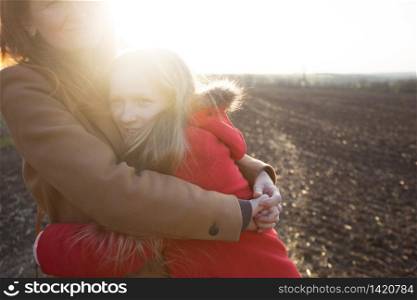 family - happy mother and daughter in the field On the Sunset