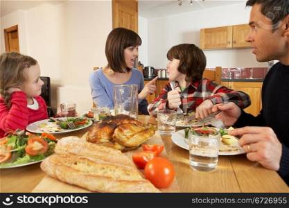 Family Having Argument Whilst Eating Lunch Together In Kitchen