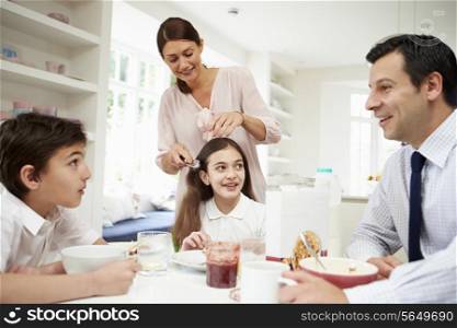 Family Having Breakfast Before Husband Goes To Work