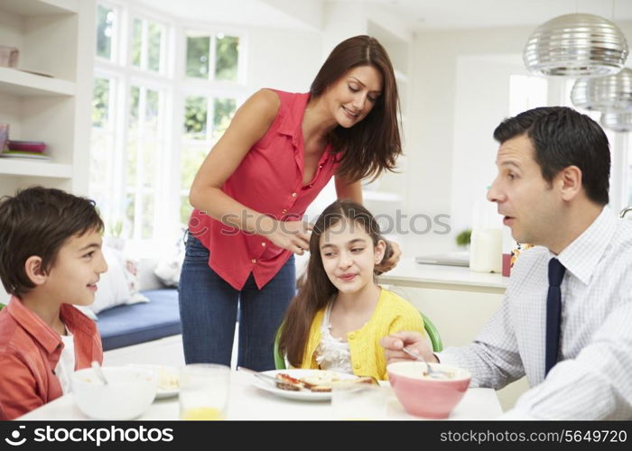 Family Having Breakfast Before Husband Goes To Work