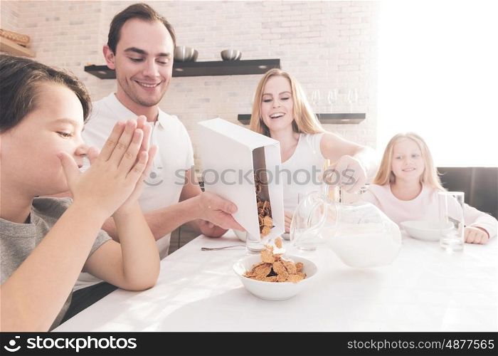 Family having breakfast. Family having breakfast with flakes and milk