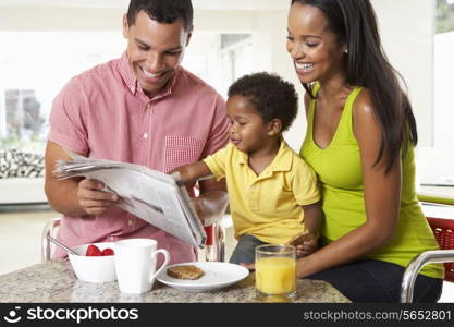 Family Having Breakfast In Kitchen Together